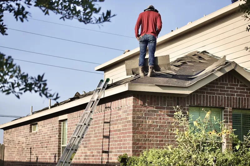 Professional roofer working on a residential roof in Mont Clare